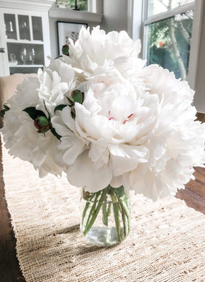 Fresh white peonies in the kitchen. Fresh flowers are a must-have for home.
